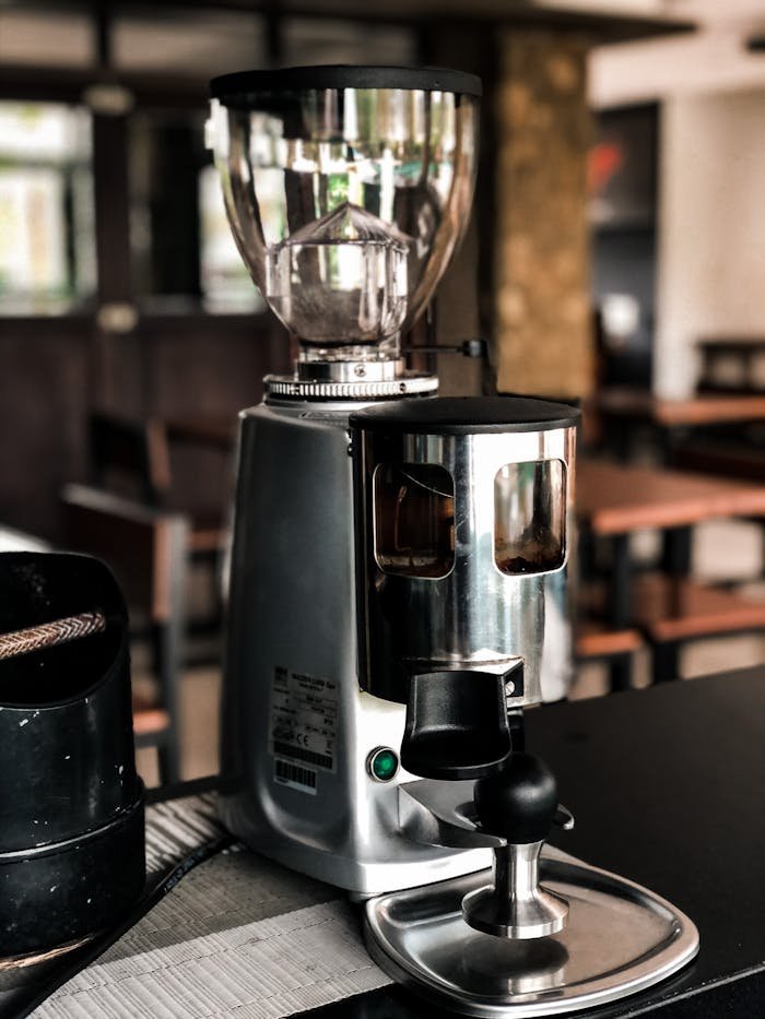 Sleek espresso machine on a counter in a warm, inviting café atmosphere.